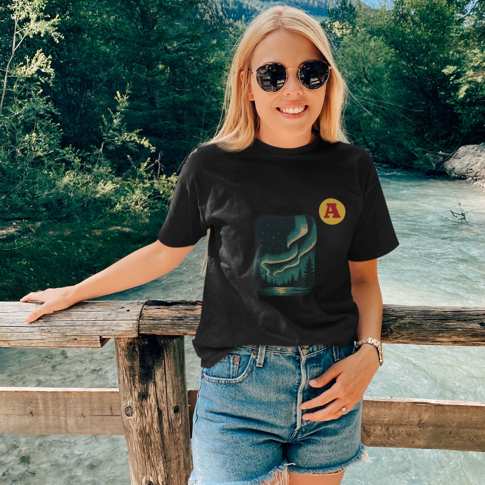Woman wearing a black Northern lights Aurora T shirt from the Canadian ABC collection by Maple Beaver