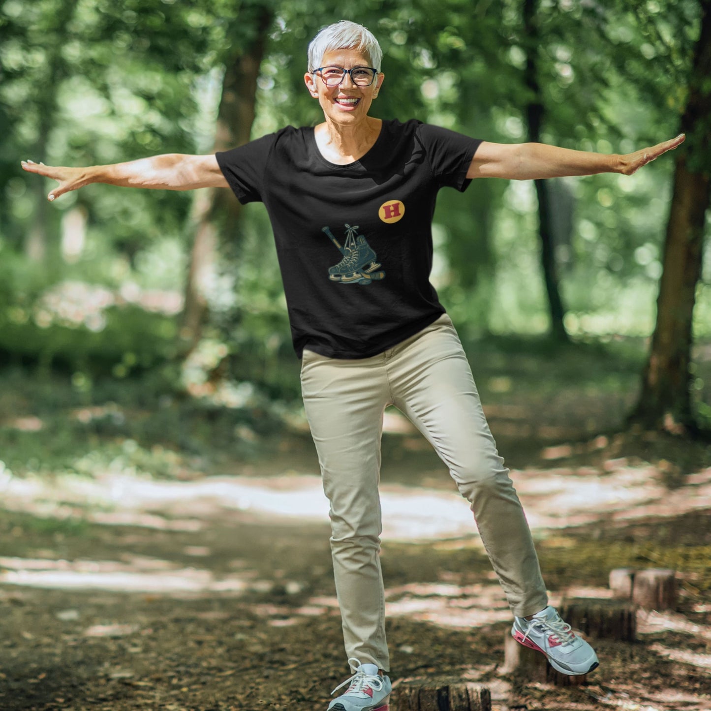 Woman wearing a Black colour Canadian Made Hockey T Shirt in Organic Cotton from the Canadian ABC collection by Maple Beaver