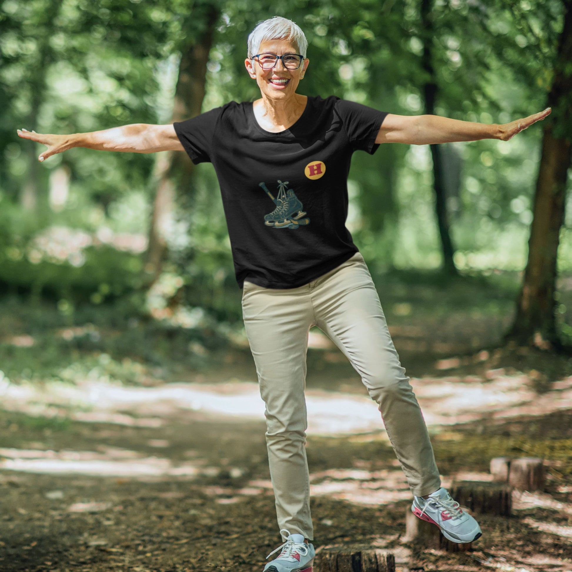 Woman wearing a Black colour Canadian Made Hockey T Shirt in Organic Cotton from the Canadian ABC collection by Maple Beaver