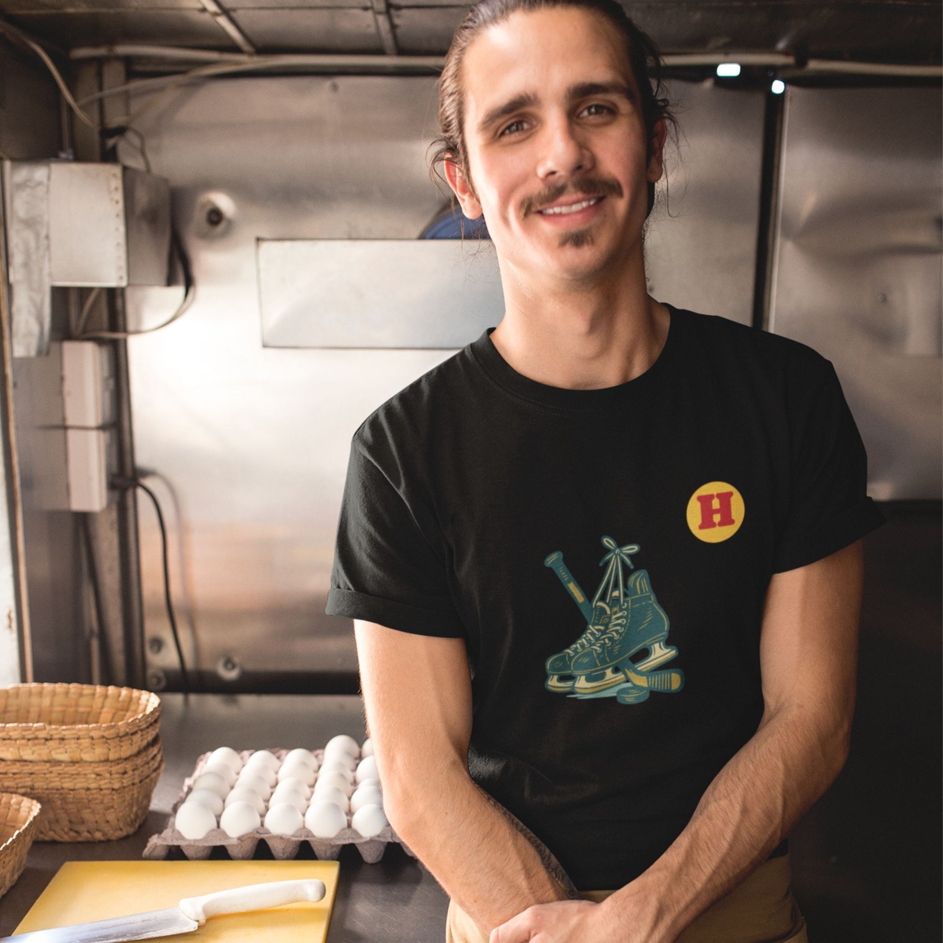 Man wearing a Black colour Canadian Made Hockey T Shirt in Organic Cotton from the Canadian ABC collection by Maple Beaver