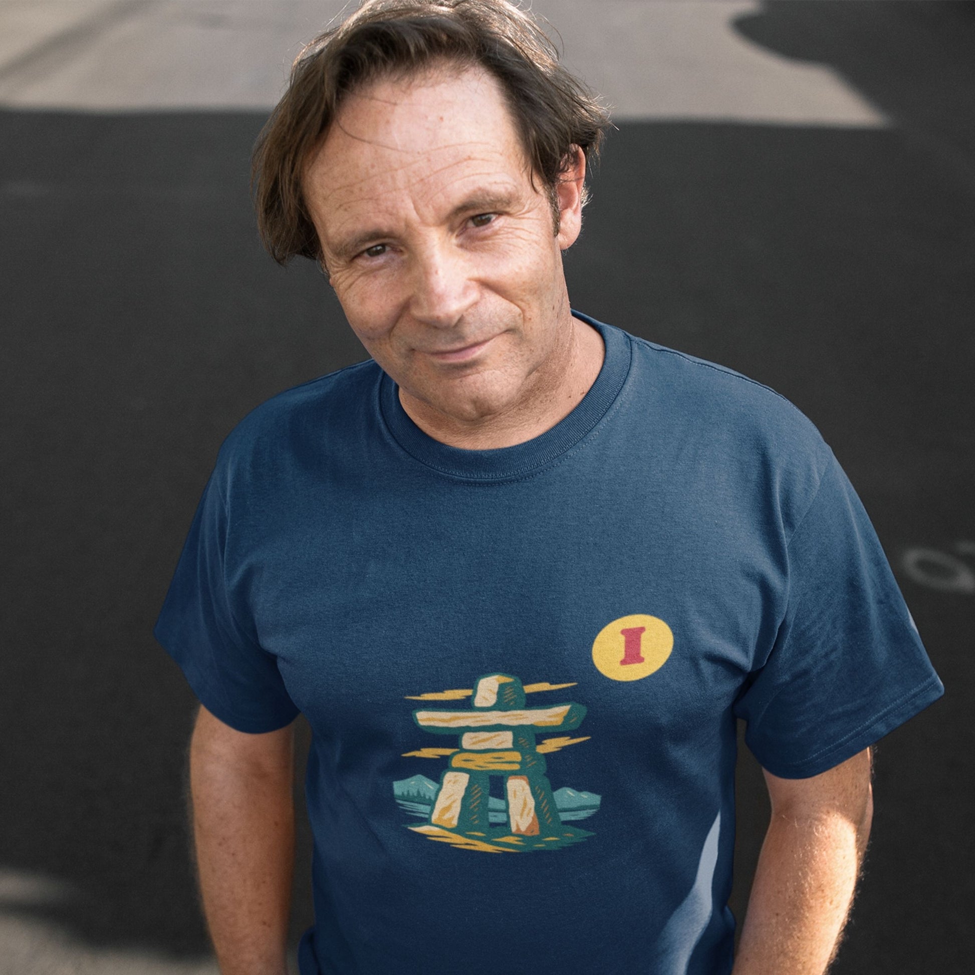 Man wearing the Canadian Made organic cotton Inukshuk T shirt in Navy colour from the Canadian Alphabet collection by Maple Beaver