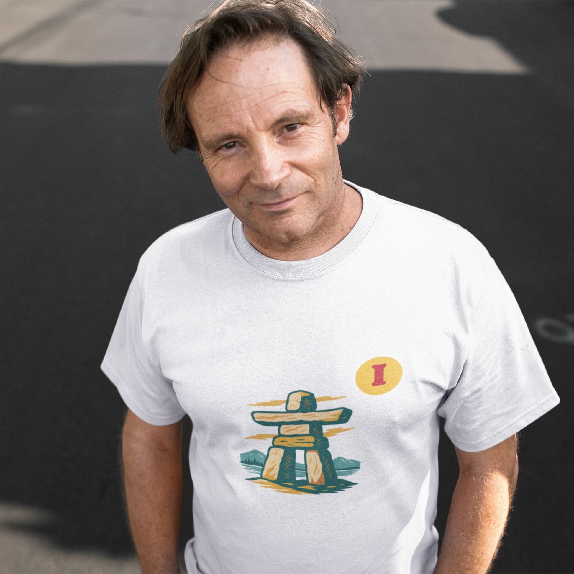 Man wearing the Canadian Made organic cotton Inukshuk T shirt in White colour from the Canadian Alphabet collection by Maple Beaver