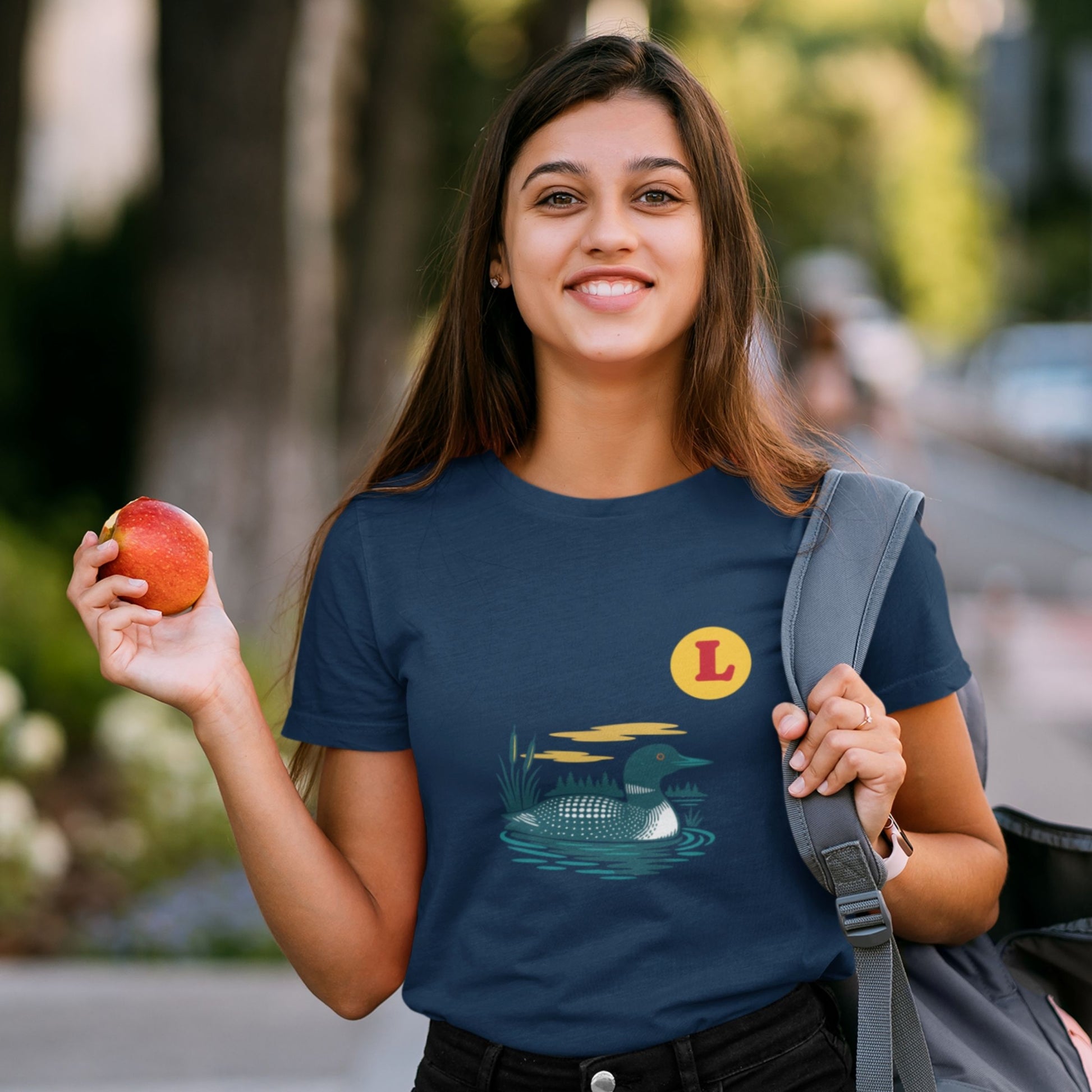 Woman wearing a Navy colour Canadian Made T shirt featuring the Loon Duck from the Canadian ABC collection by Maple Beaver