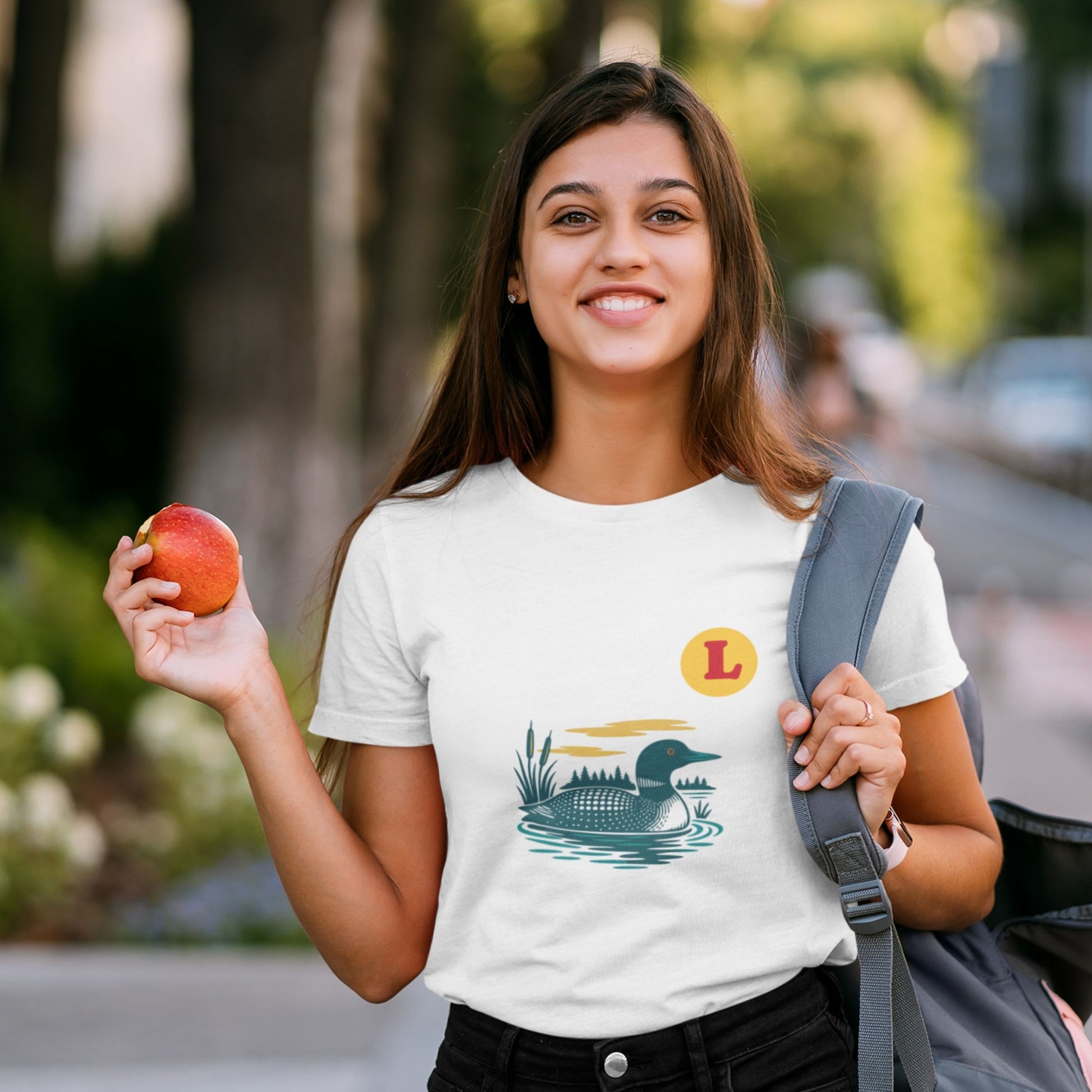 Woman wearing a White colour Canadian Made T shirt featuring the Loon Duck from the Canadian ABC collection by Maple Beaver