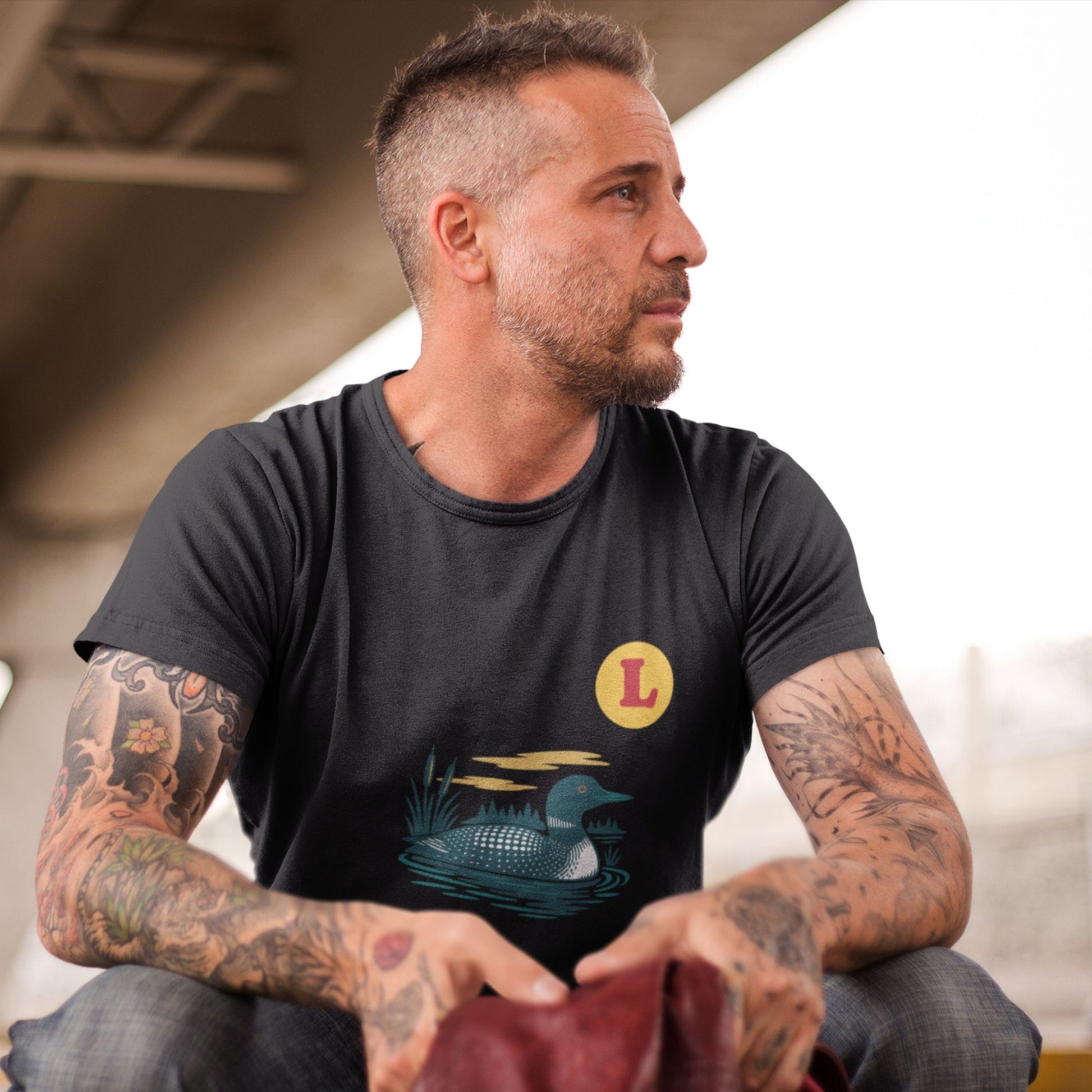 Man wearing a Black colour Canadian Made T shirt featuring the Loon Duck from the Canadian ABC collection by Maple Beaver