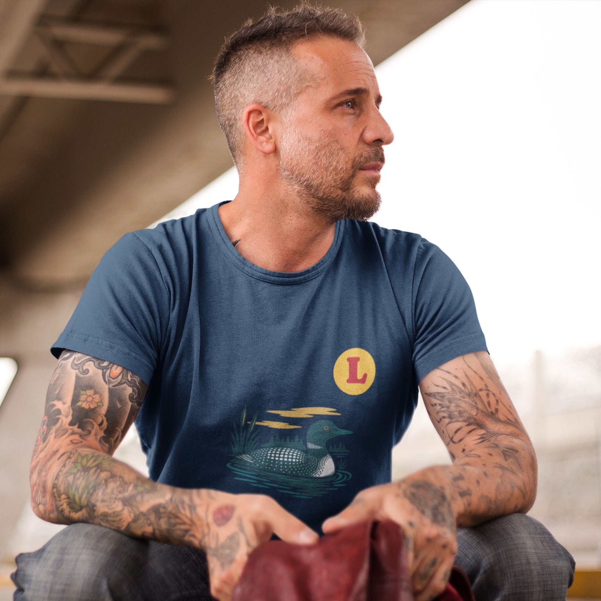 Man wearing a Navy colour Canadian Made T shirt featuring the Loon Duck from the Canadian ABC collection by Maple Beaver