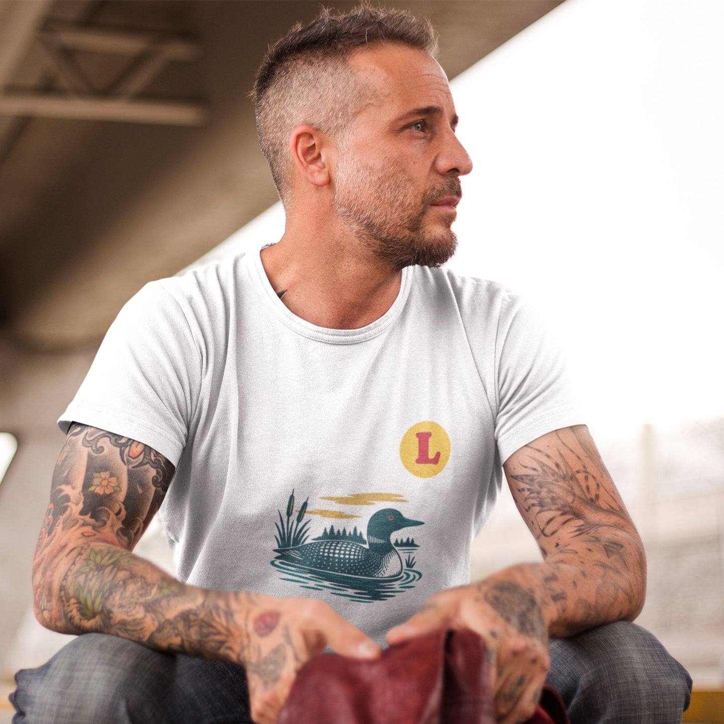 Man wearing a White colour Canadian Made T shirt featuring the Loon Duck from the Canadian ABC collection by Maple Beaver