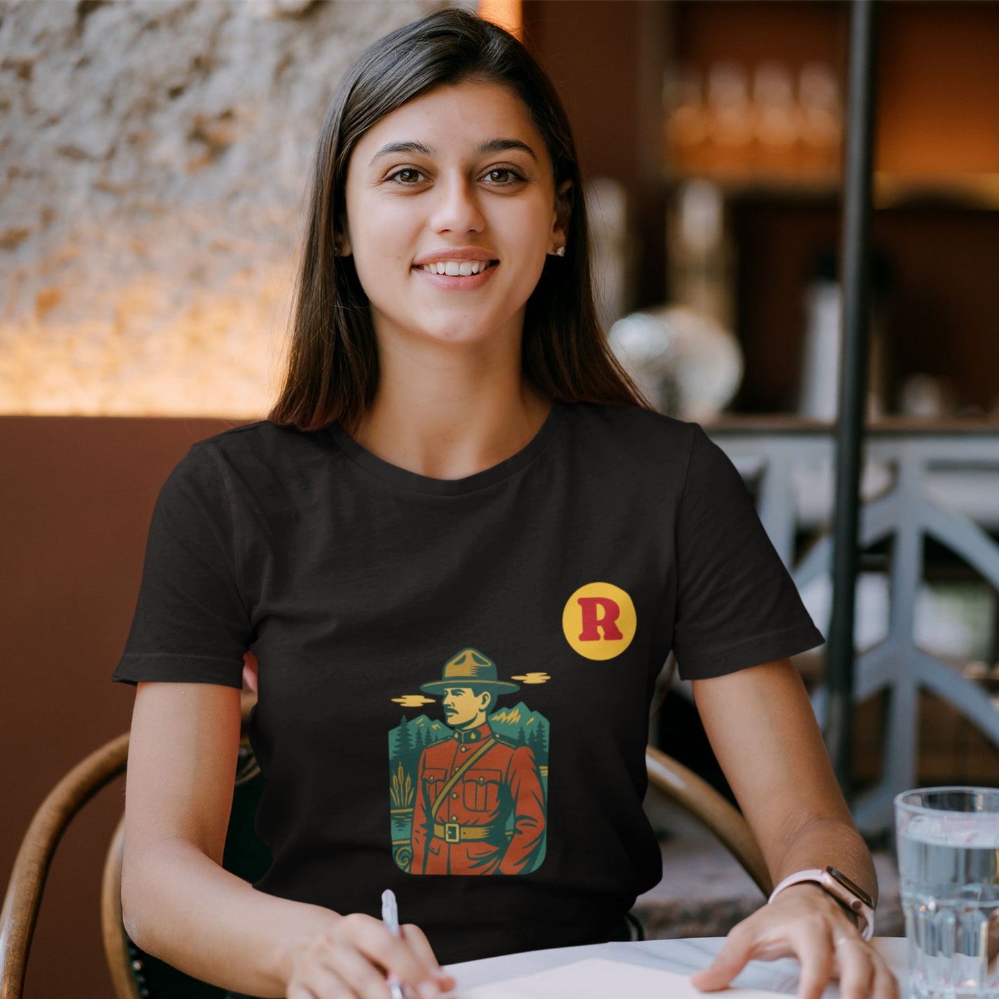 Woman wearing a RCMP Canada T Shirt in Black colour from the Canadian Alphabet collection by Maple Beaver