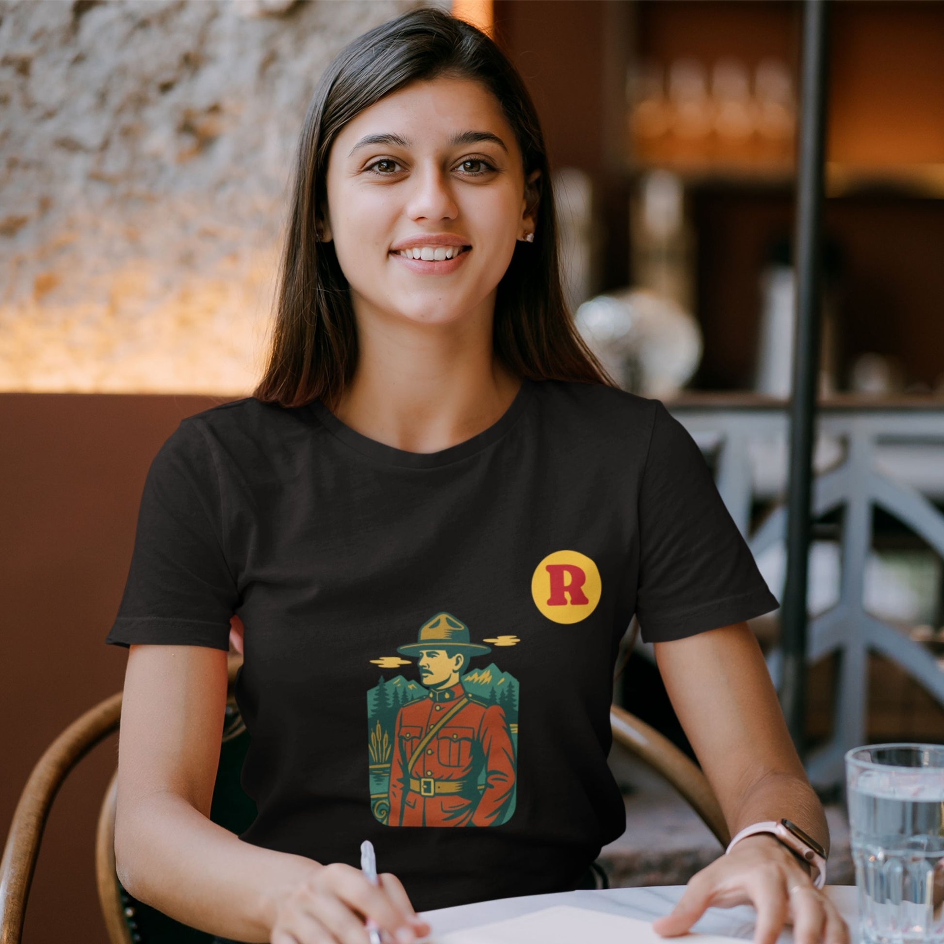 Woman wearing a RCMP Canada T Shirt in Black colour from the Canadian Alphabet collection by Maple Beaver