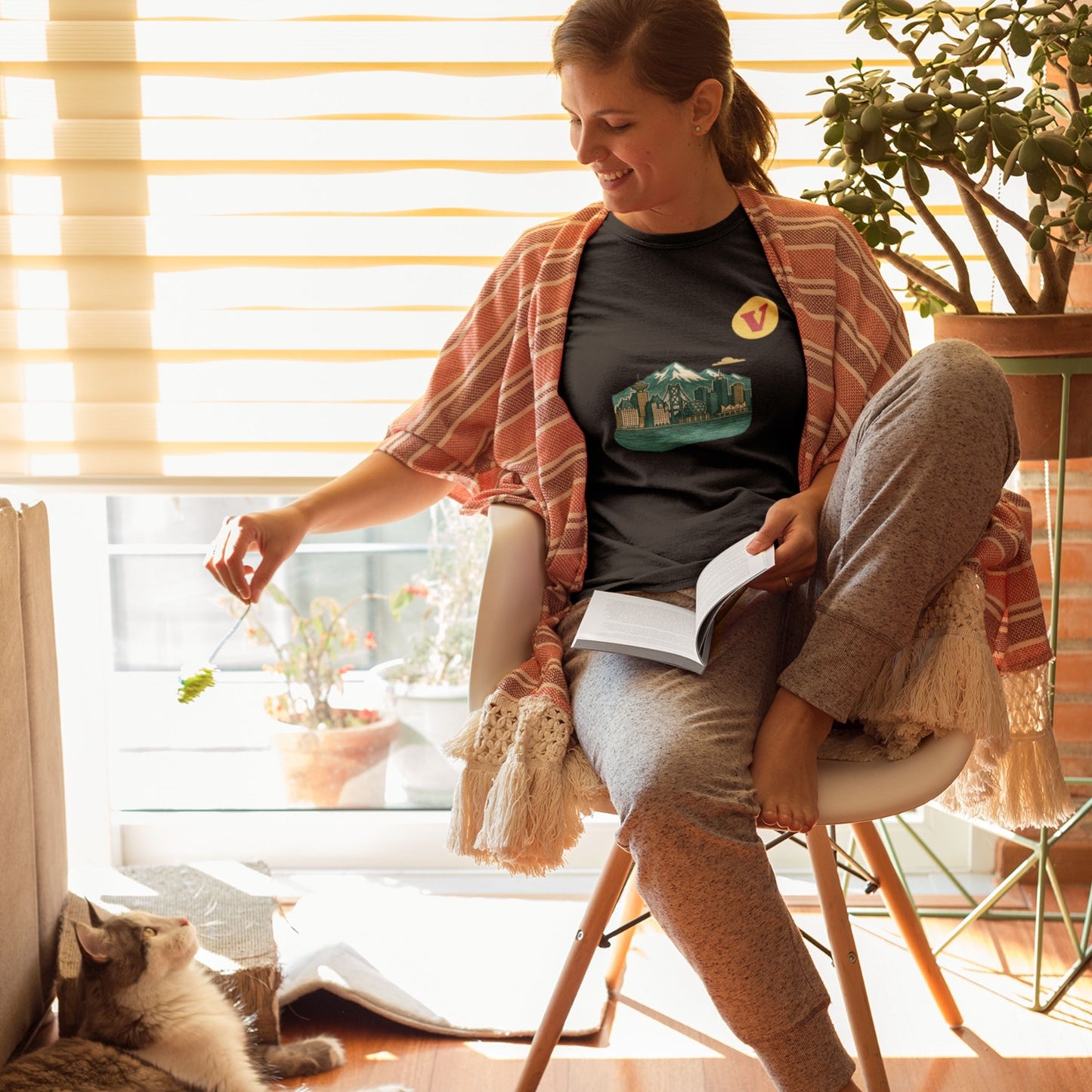 Woman wearing the Vancouver Canada T Shirt in Black colour from the Canadian ABC collection by Maple Beaver. Made in Canada in Organic Cotton.