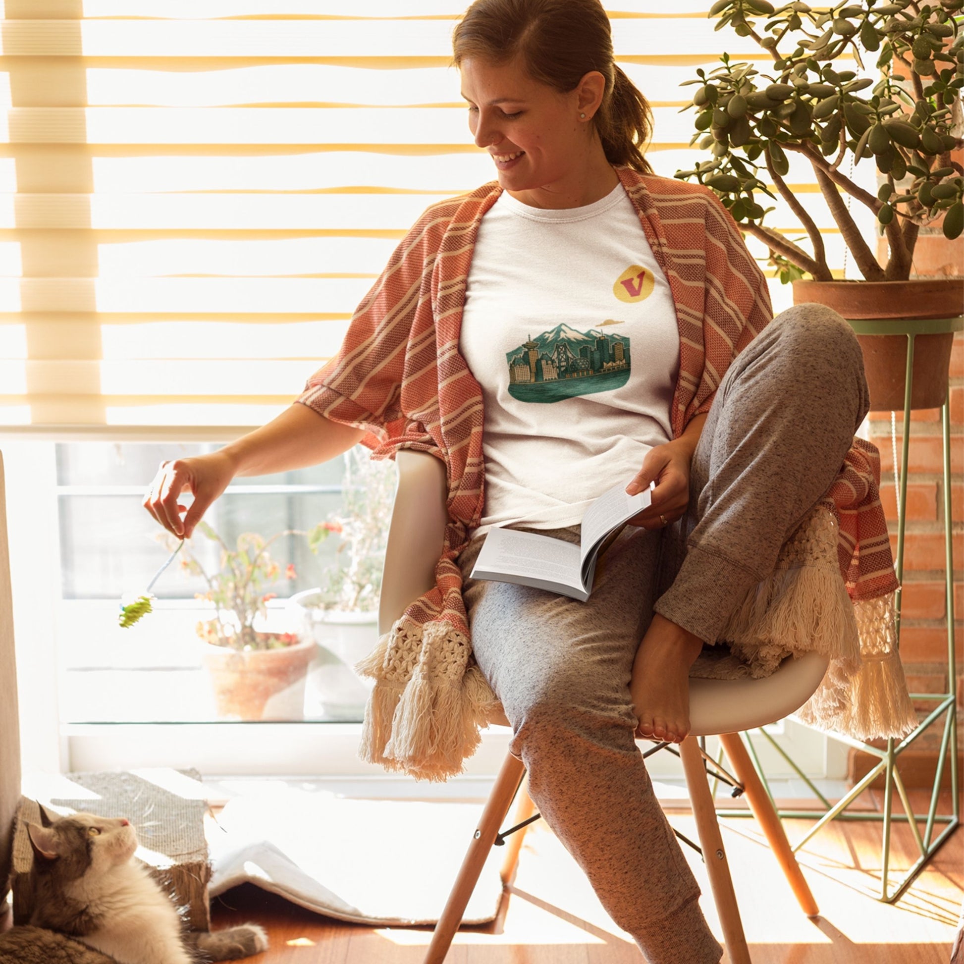 Woman wearing the Vancouver Canada T Shirt in white colour from the Canadian ABC collection by Maple Beaver. Made in Canada in Organic Cotton.