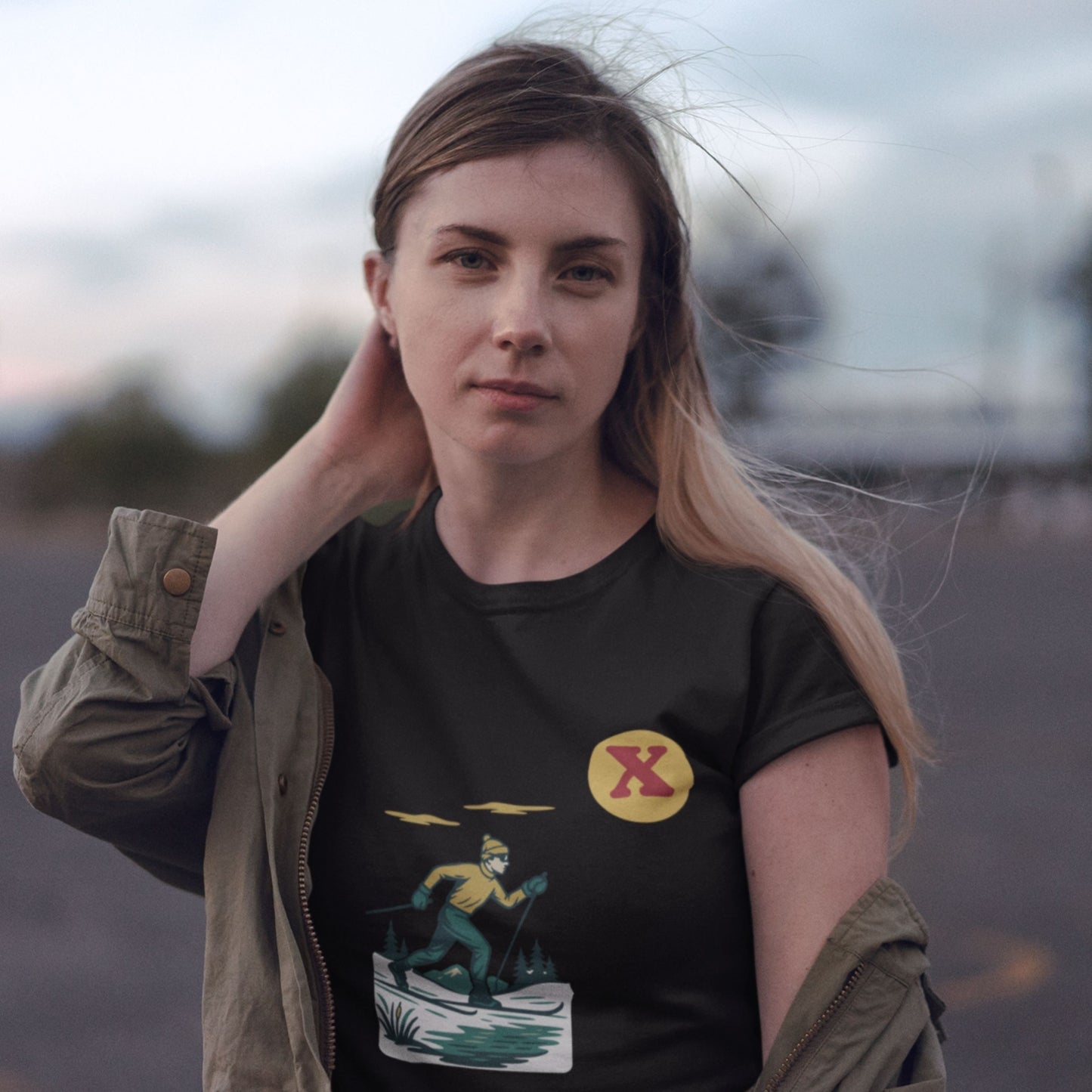 Woman wearing the Canadian Made organic cotton cross country Skiing T shirt  in Black from the Canadian Alphabet collection by Maple Beaver