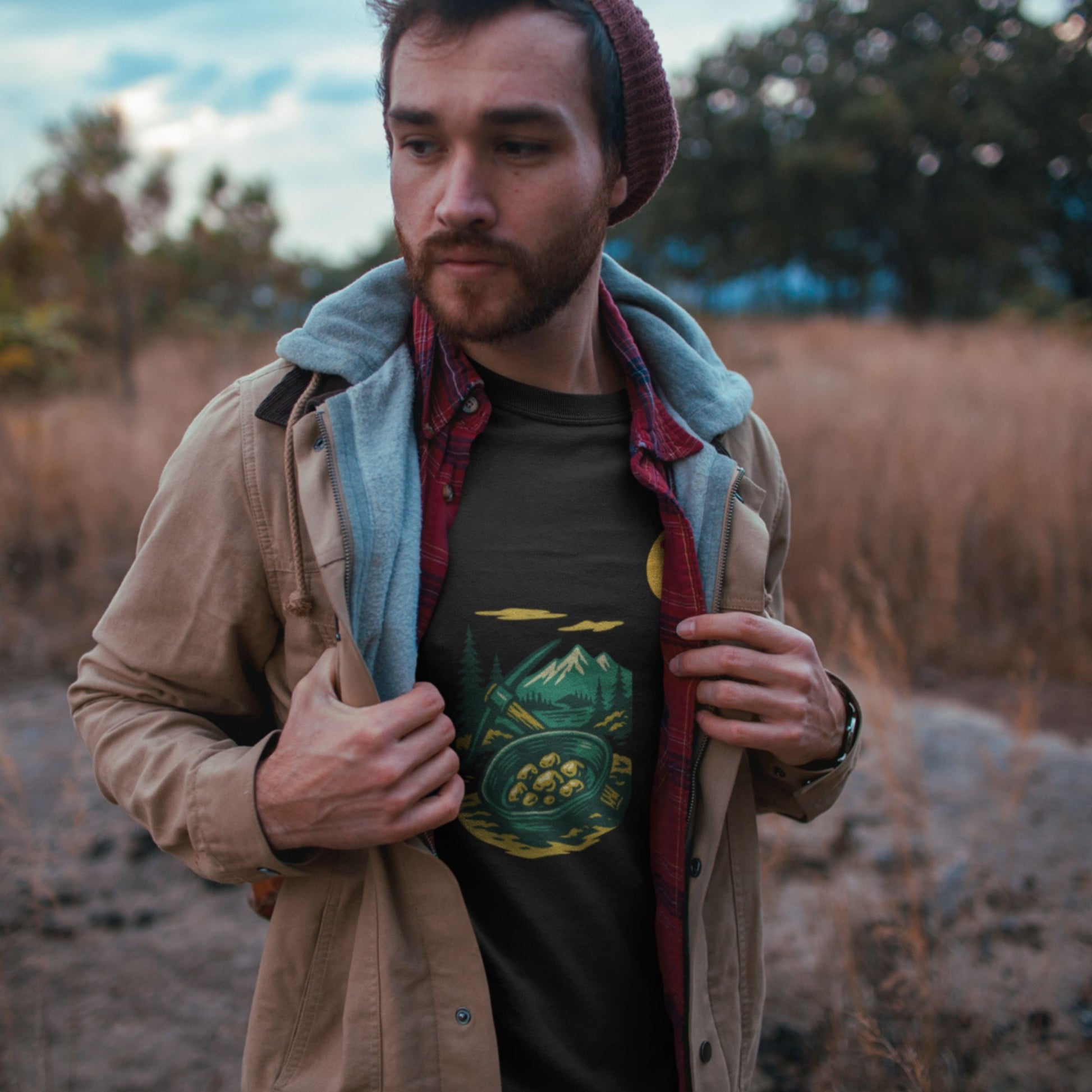 Man standing in a field wearing a jacket with the Canadian Made Yukon T shirt in Black colour from the Canadian ABC collection by Maple Beaver