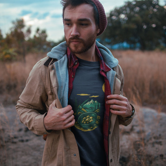 Man standing in a field wearing a jacket with the Canadian Made Yukon T shirt in Navy colour from the Canadian ABC collection by Maple Beaver