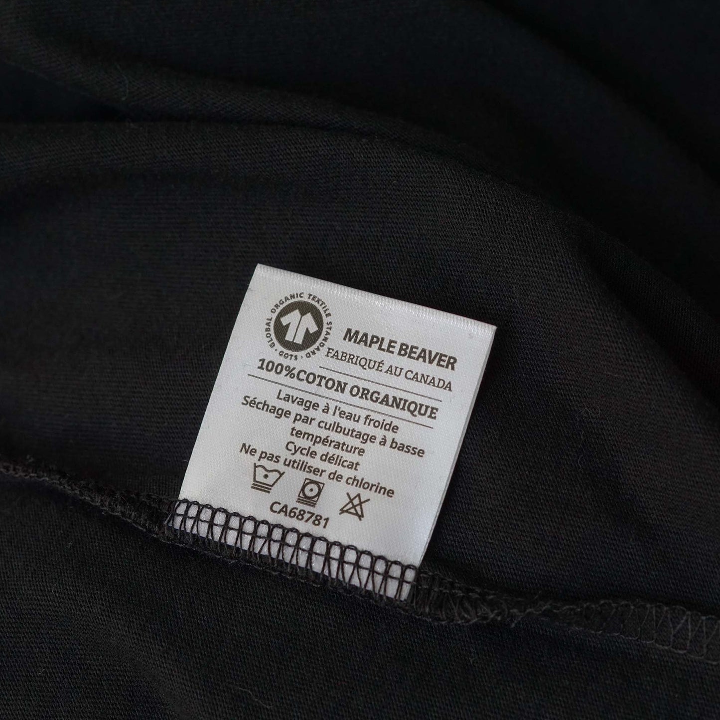 Canadian Made Organic Cotton T shirt in Black colour by Maple Beaver, closeup of care instructions tag