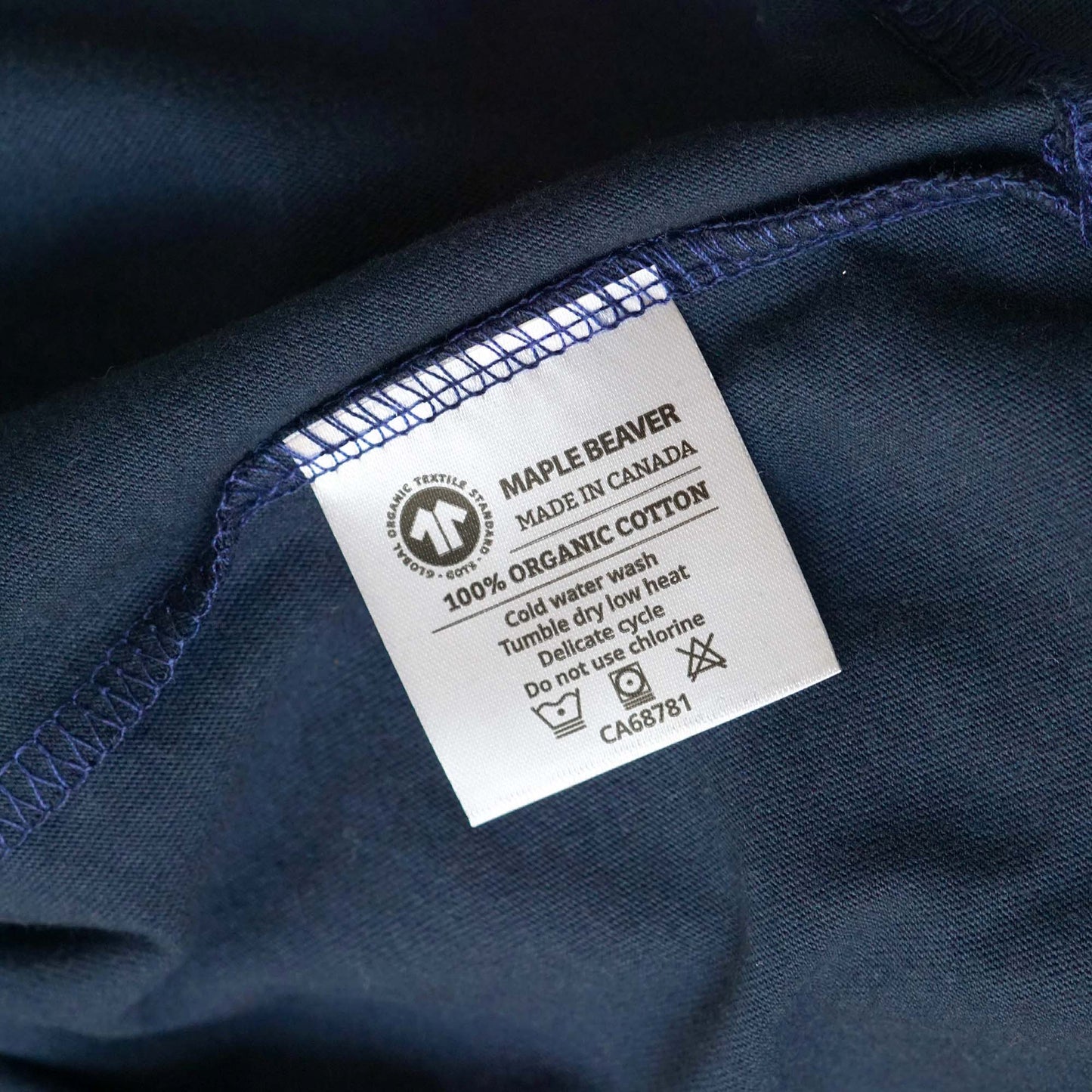 Canadian Made Organic Cotton T shirt in Navy colour by Maple Beaver, closeup of care label.