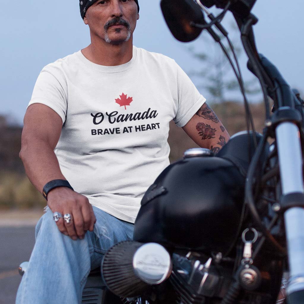 Man on a bike wearing the O Canada Brave at Heart Canadian TShirt in White colour by Maple Beaver.