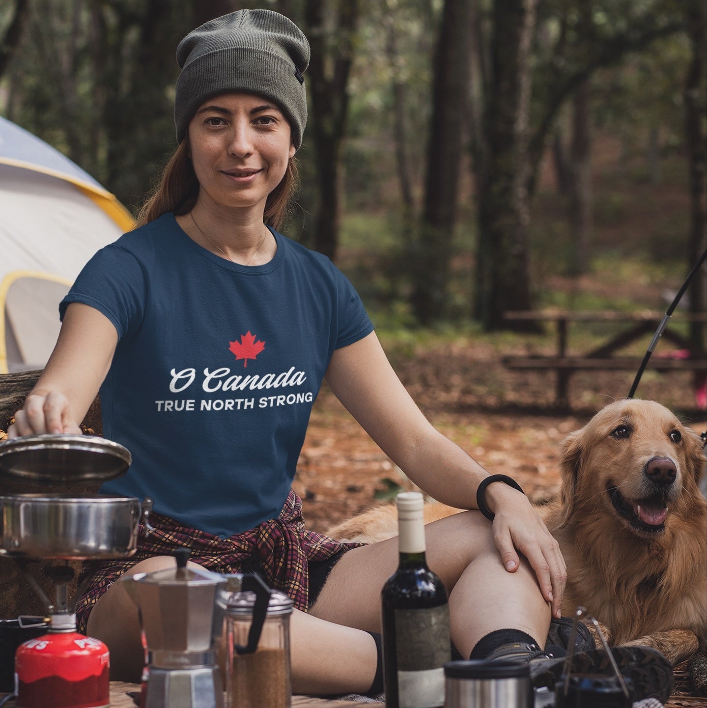 Woman at a campsite wearing the True North Strong Canadian T Shirt in Navy colour by Maple Beaver.