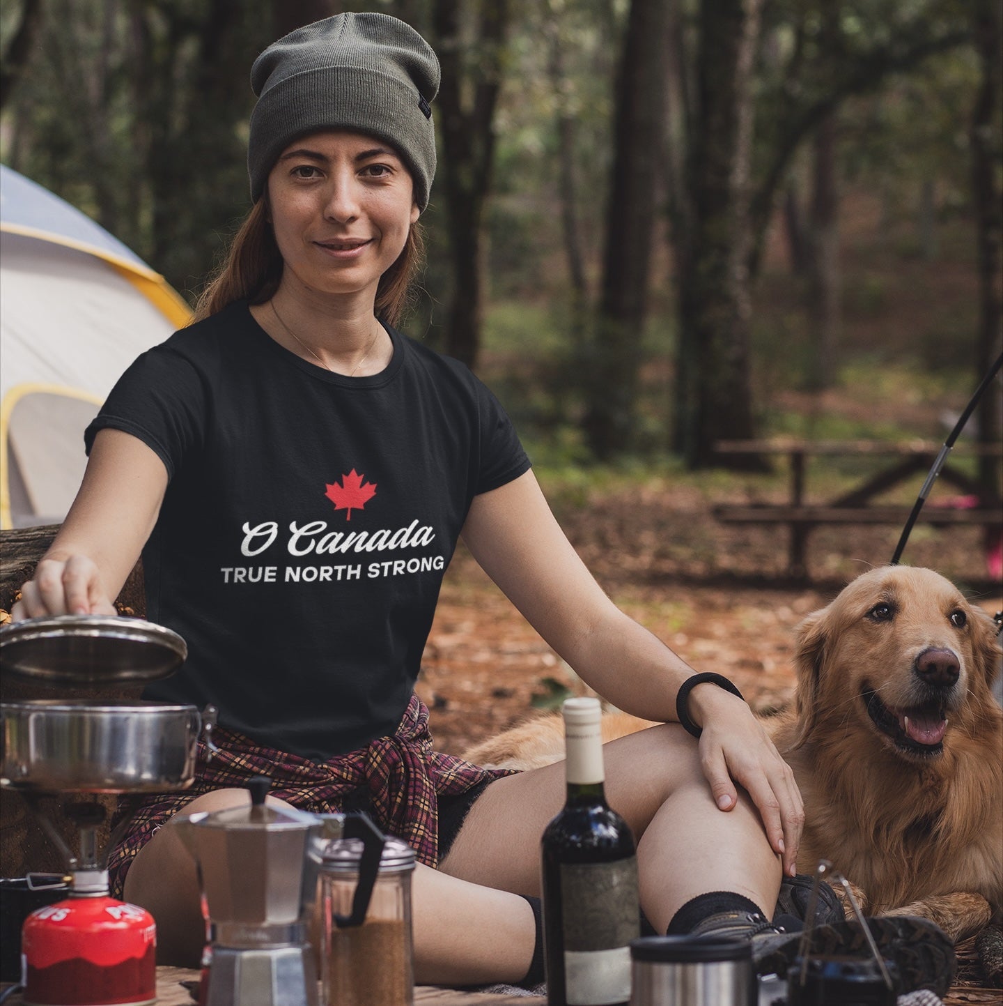 Woman at a campsite wearing the True North Strong Canadian T Shirt in Black colour by Maple Beaver.