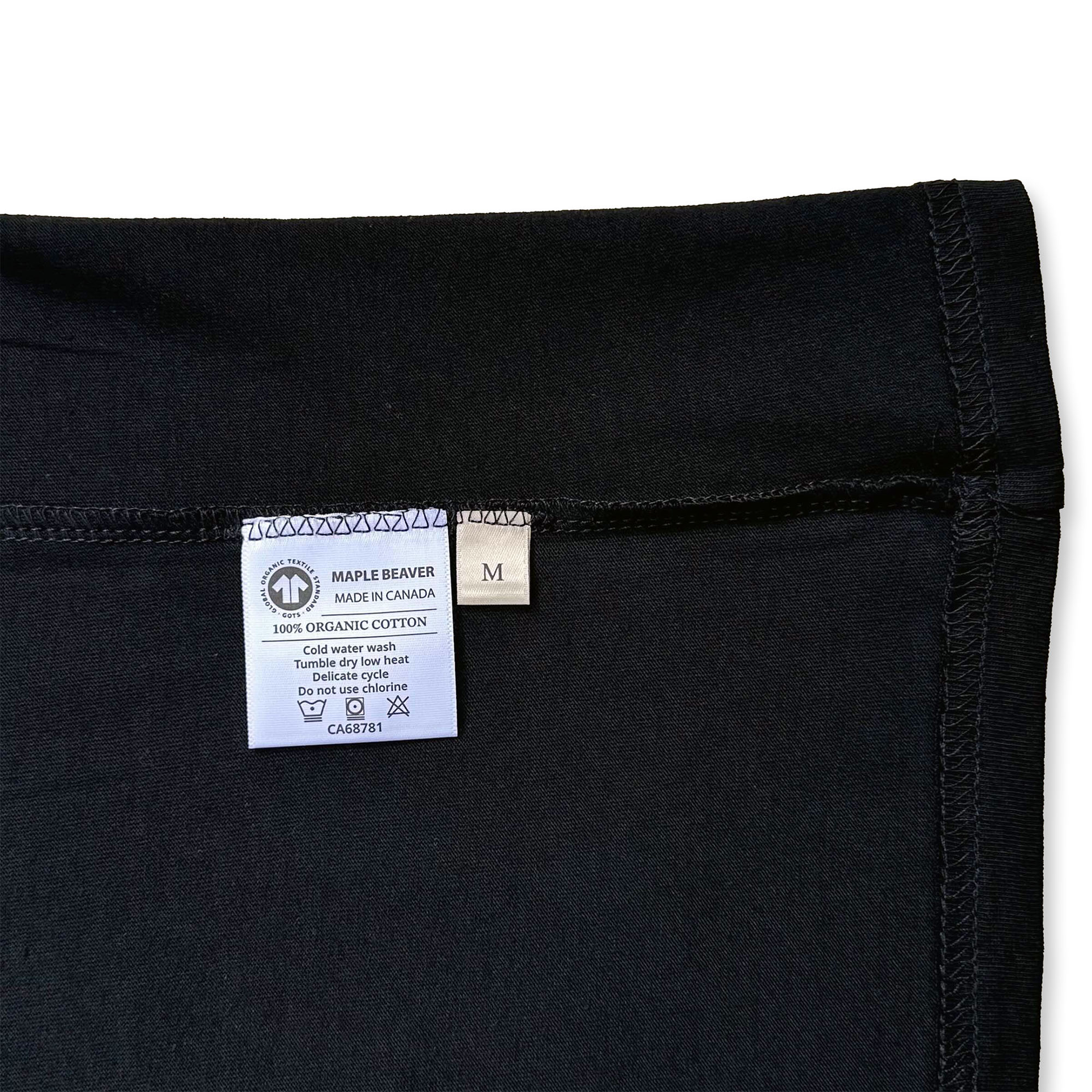 Canadian Made Organic Cotton T shirt in Black colour by Maple Beaver, closeup of care instructions tag