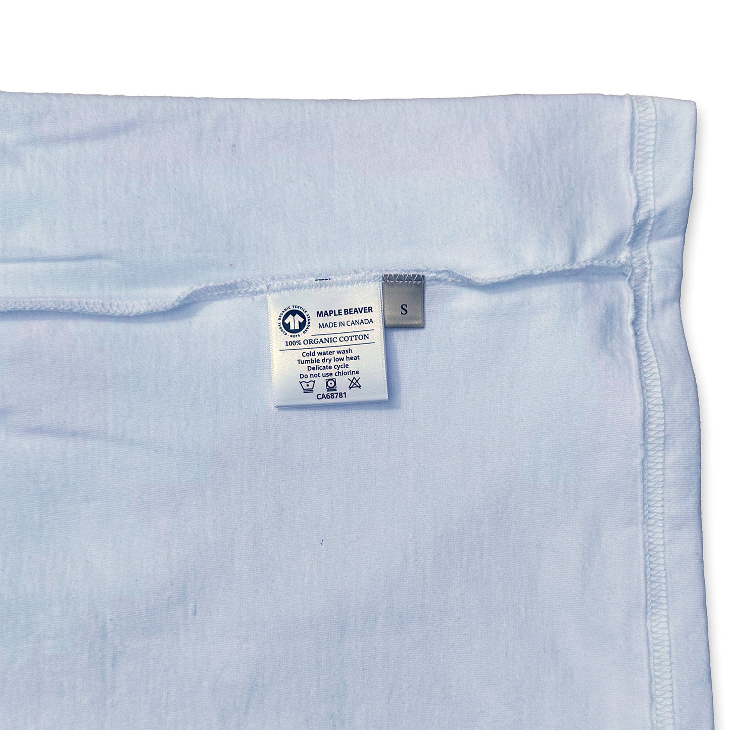 Canadian Made Organic Cotton T shirt in White colour by Maple Beaver, closeup of care instructions.