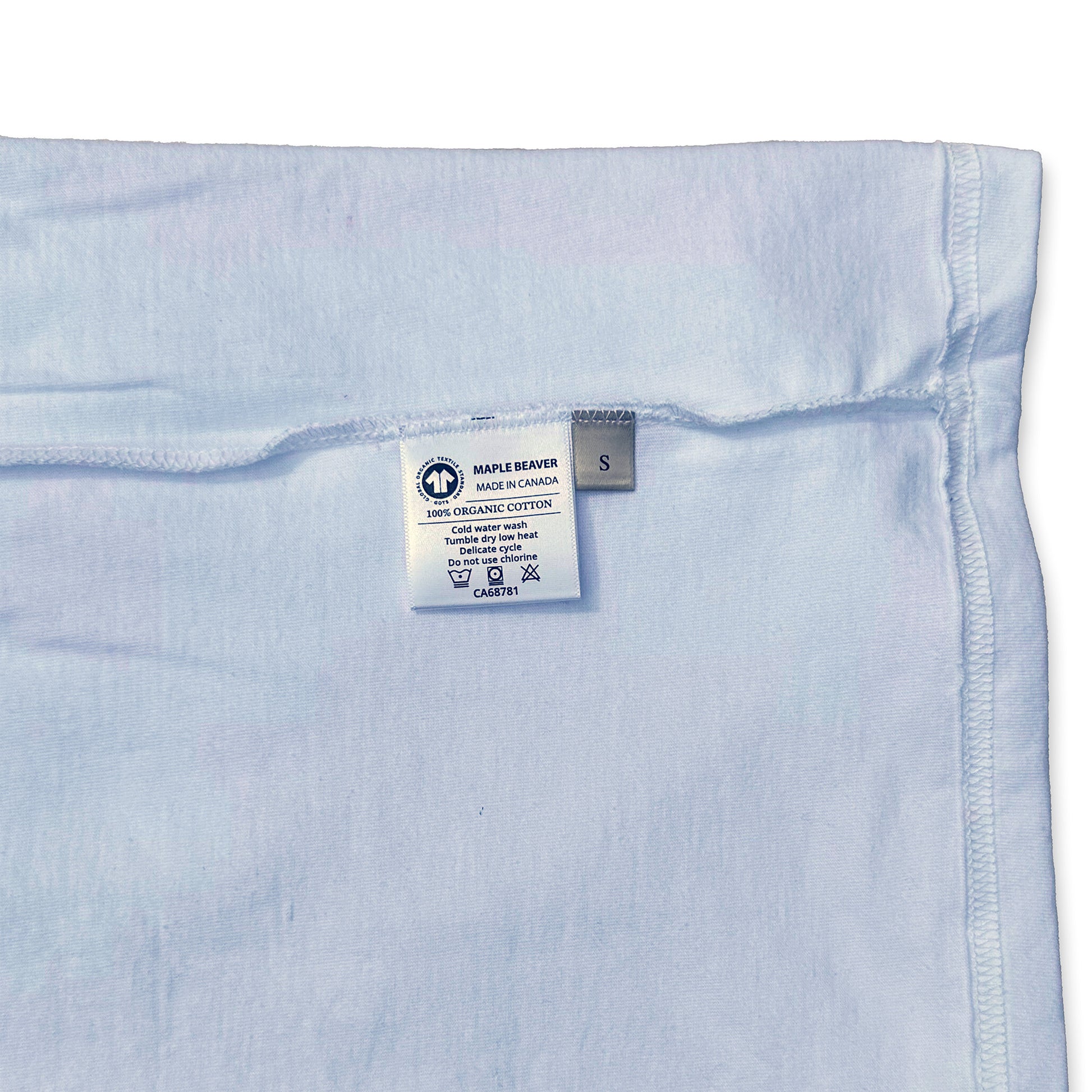 Canadian Made Organic Cotton T shirt in White colour by Maple Beaver, closeup of care instructions.