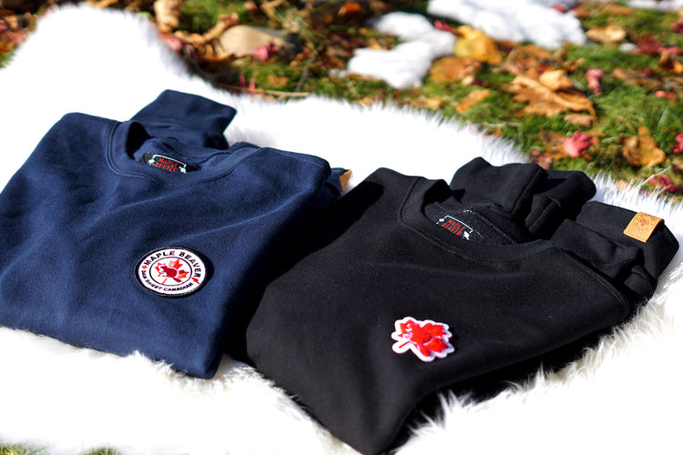 Maple Beaver sweatshirts Canadian made organic cotton in navy and black color lying folded on the ground