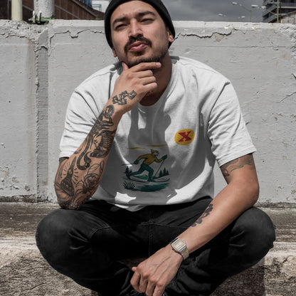 Man sitting against a concrete wall wearing the Made in Canada cross country skiing T shirt in white 