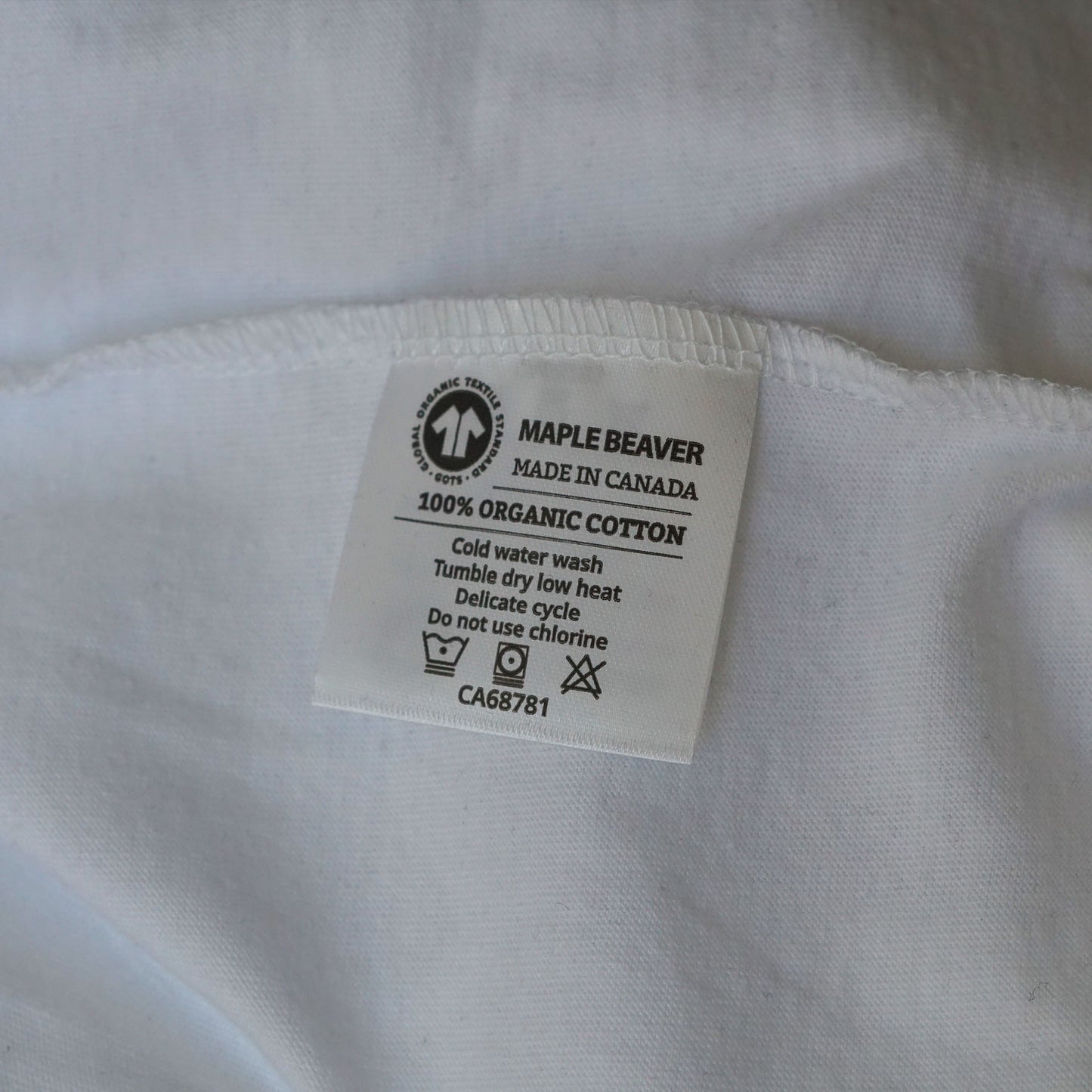 Canadian Made Organic Cotton T shirt in White colour by Maple Beaver, closeup of care instructions.
